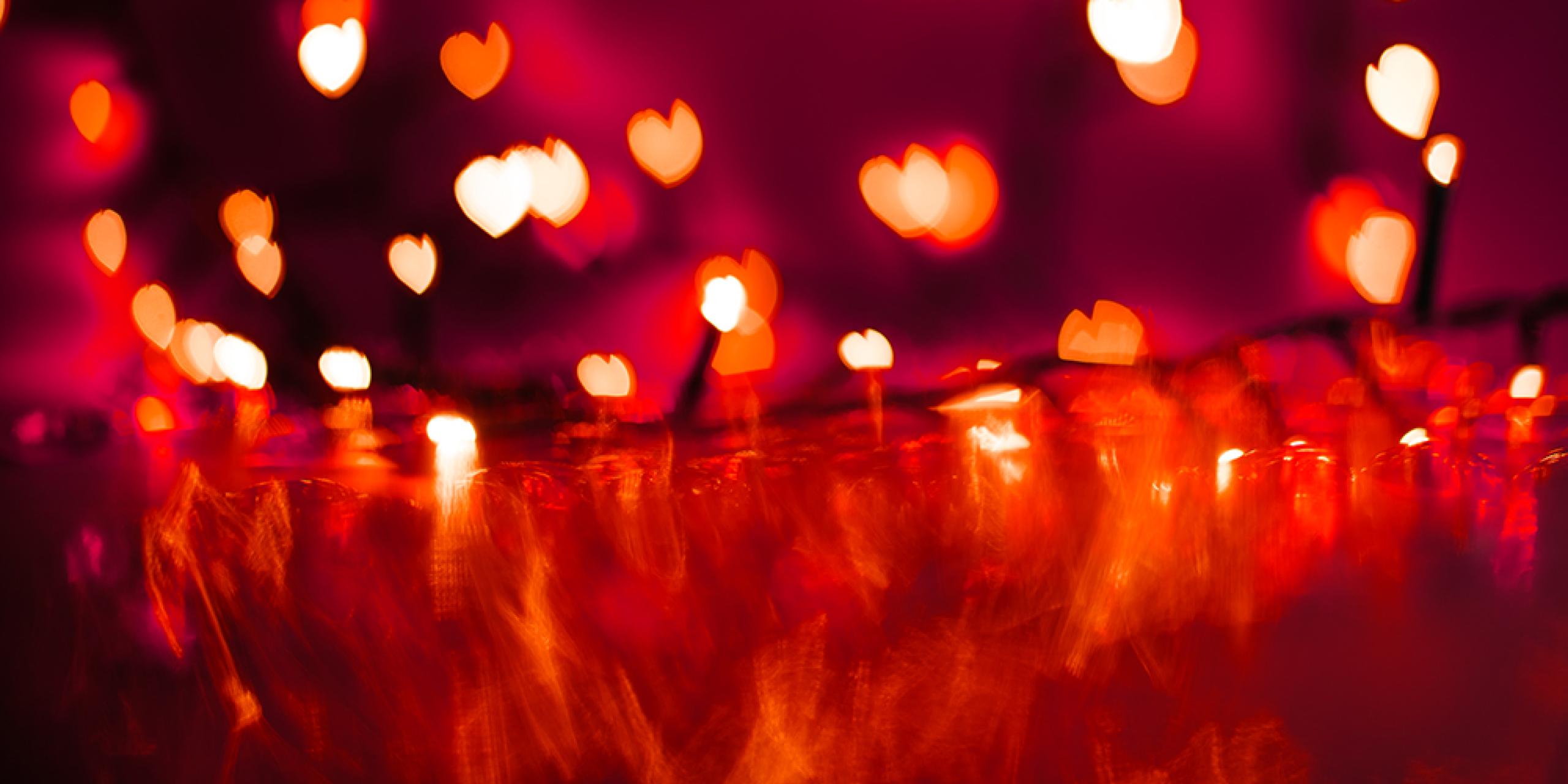 Red image, with blurry glowing heart fairy lights.
