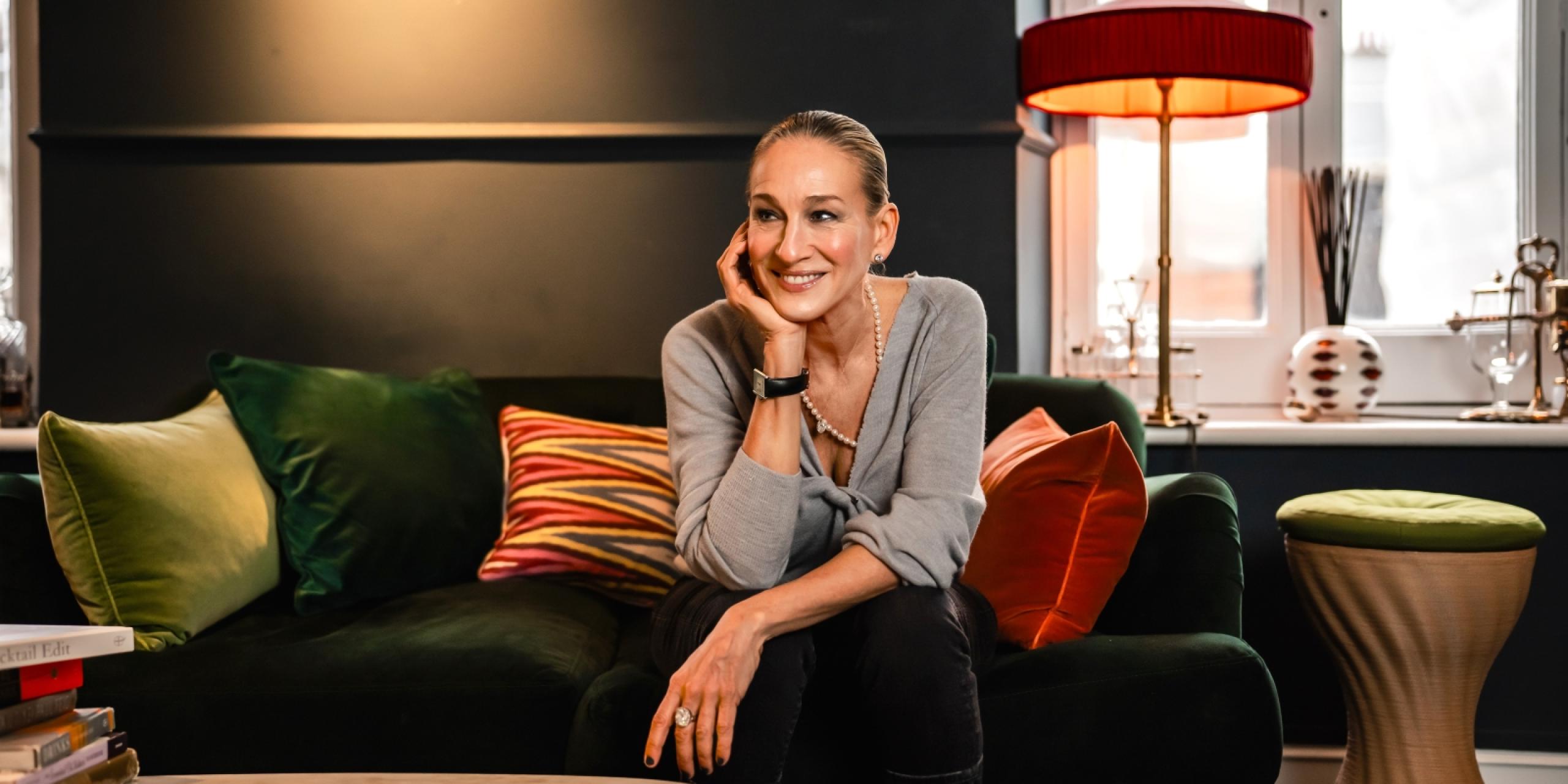 Sarah Jessica Parker sitting on a green sofa
