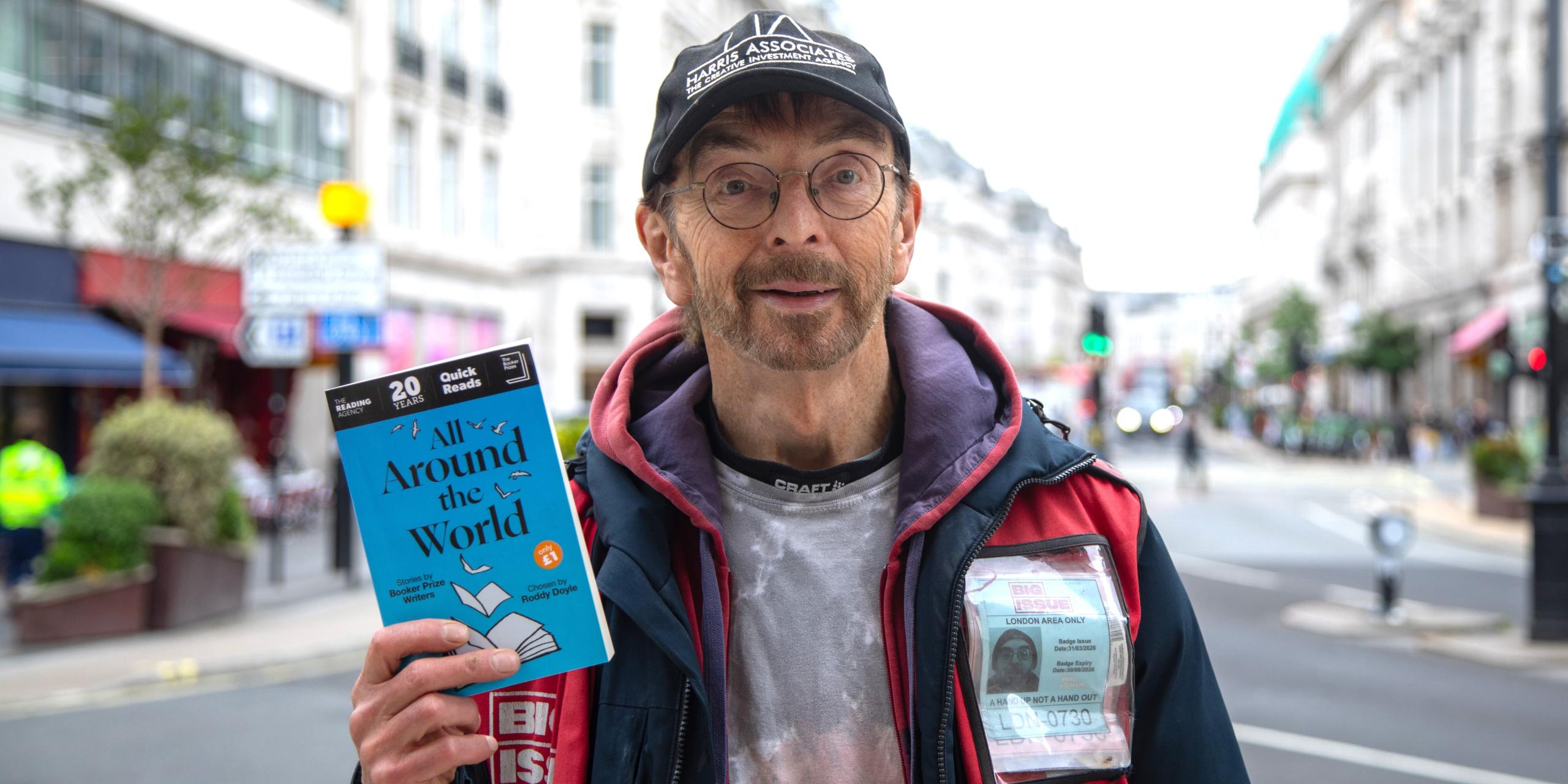 George Anderson, a Big Issue vendor, with All Around the World: Stories by Booker Prize Writers,