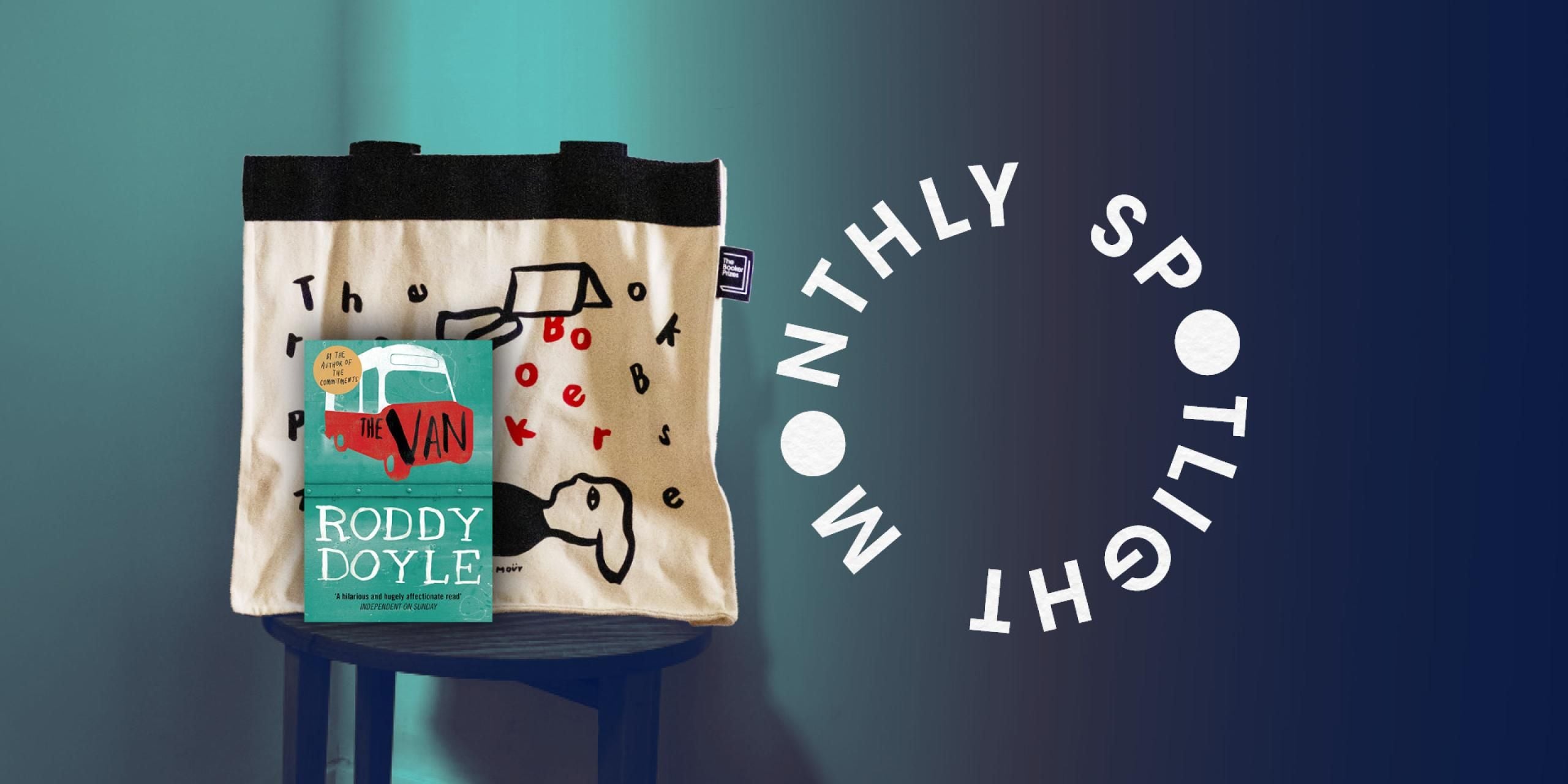 A Booker Prizes tote bag is on a stool with an image of the book cover. There is a blue background with the monthly spotlight lettering in a circle. 
