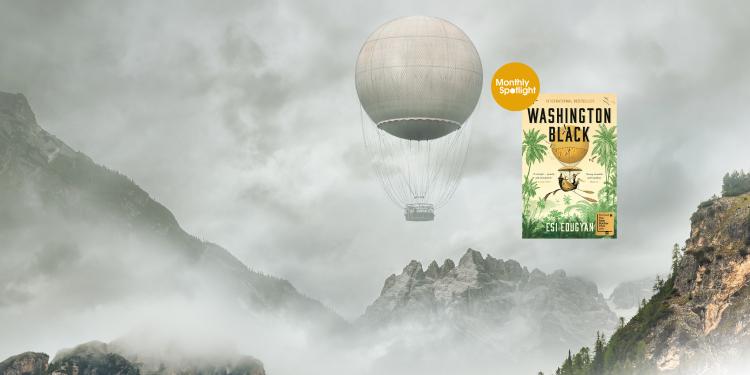 Front cover of Washing Black with orange monthly spotlight badger over a picture of an air balloon flying amongst mountains.