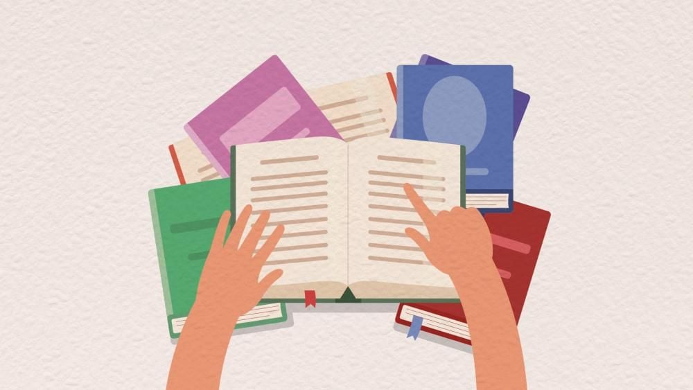 Illustration of an open book being held open by a pair of hands, with several other books underneath