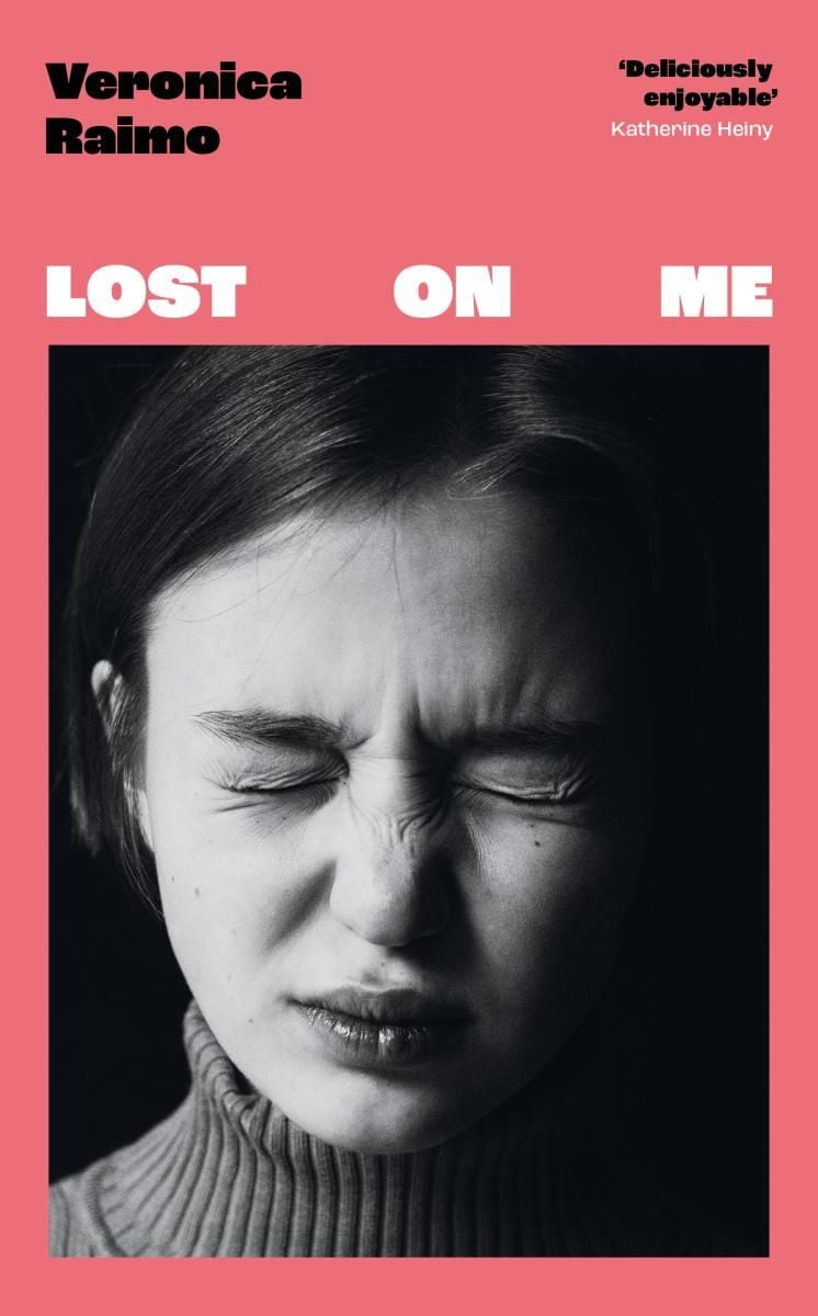 Pink book cover of Lost on Me with a black and white photo of a young woman screwing up her face.